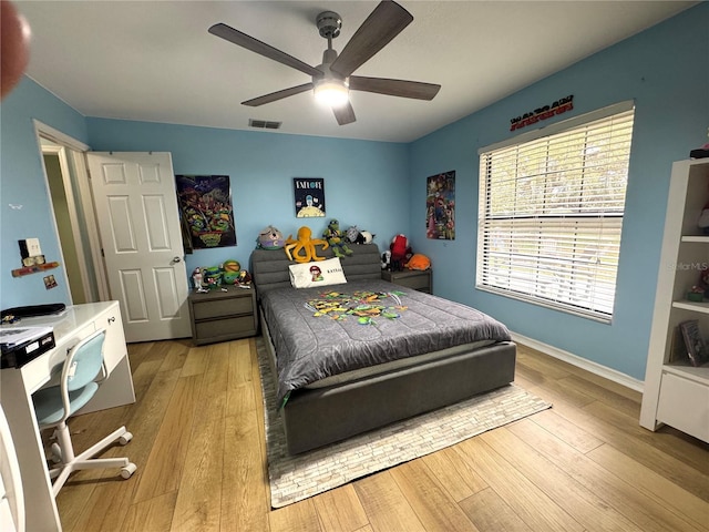 bedroom with ceiling fan and light hardwood / wood-style floors