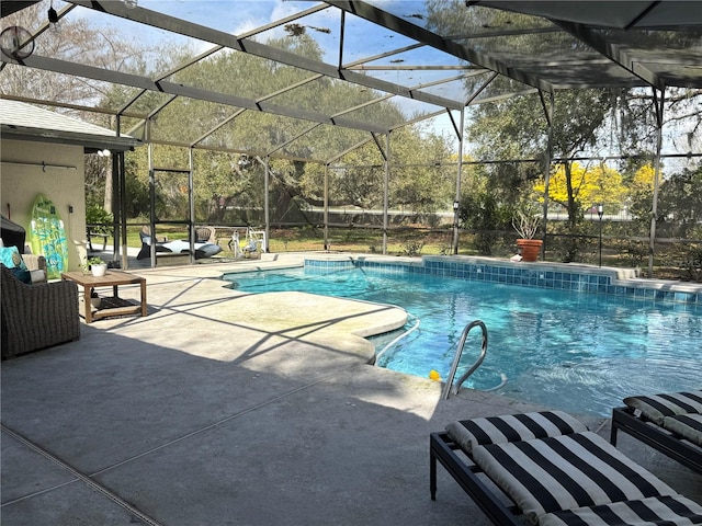 view of pool featuring glass enclosure and a patio area