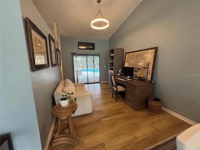 office space featuring lofted ceiling and light hardwood / wood-style floors