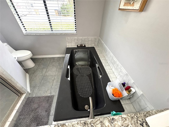 bathroom with toilet and tile patterned floors