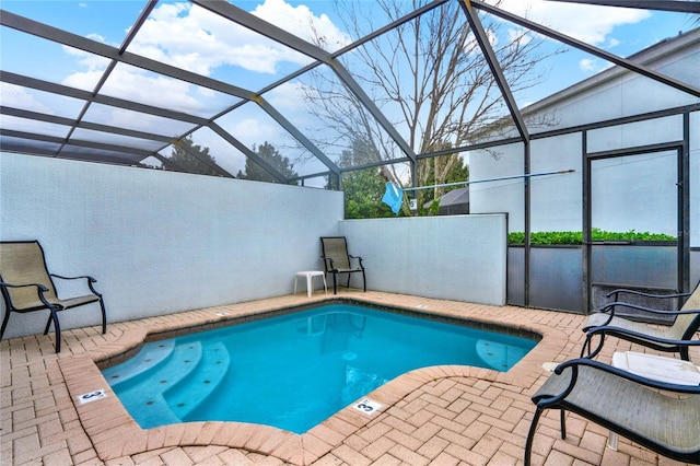 outdoor pool featuring a lanai and a patio