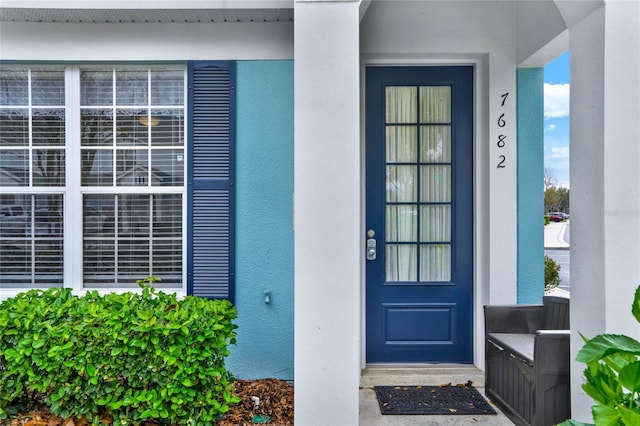 property entrance featuring stucco siding