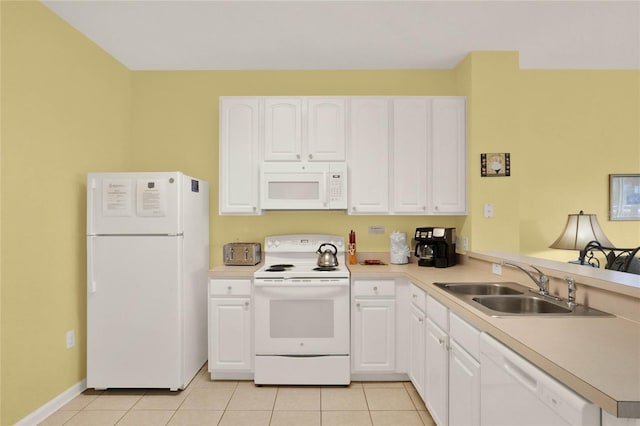 kitchen featuring a peninsula, white appliances, light tile patterned flooring, and a sink