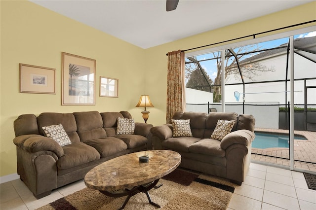 living room featuring light tile patterned flooring, ceiling fan, and baseboards