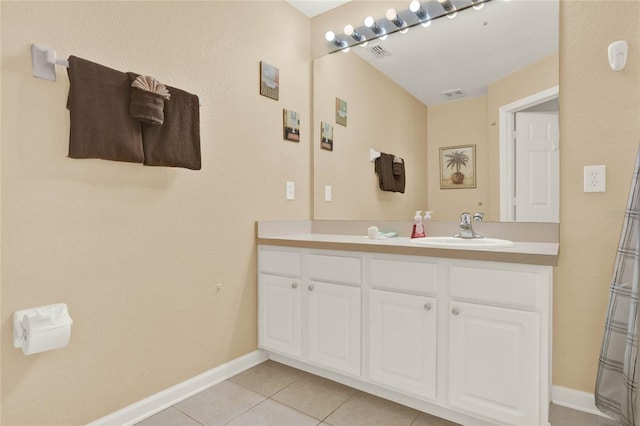 bathroom featuring tile patterned flooring, visible vents, vanity, and baseboards