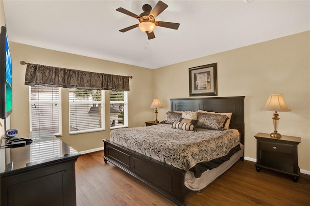 bedroom featuring ceiling fan, wood finished floors, and baseboards