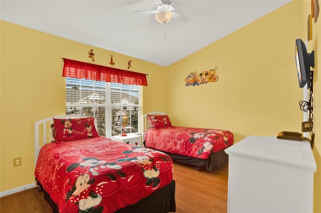 bedroom featuring ceiling fan, baseboards, and wood finished floors