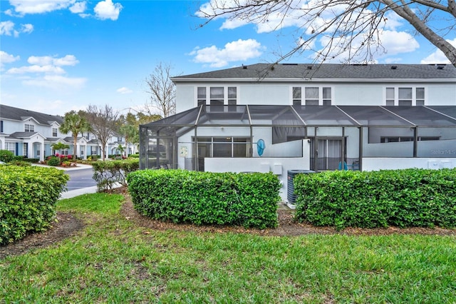 back of property featuring central AC unit, a lanai, a residential view, and stucco siding