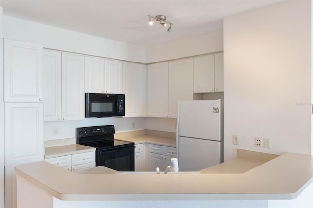 kitchen with kitchen peninsula, black appliances, and white cabinets