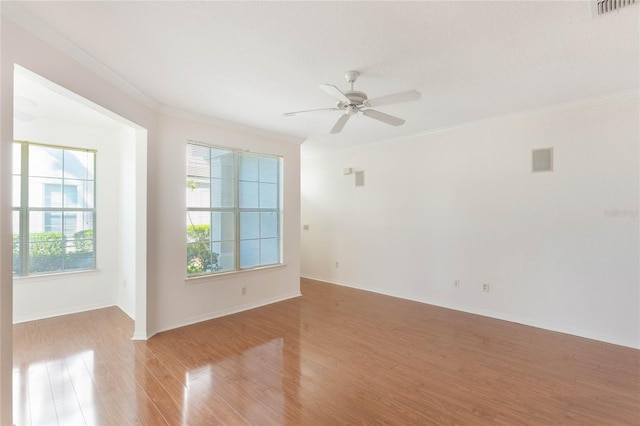 unfurnished room with light hardwood / wood-style flooring, ceiling fan, and ornamental molding