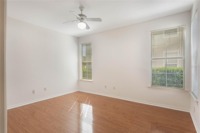 empty room featuring hardwood / wood-style flooring and ceiling fan