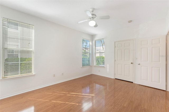 spare room with light hardwood / wood-style flooring and ceiling fan