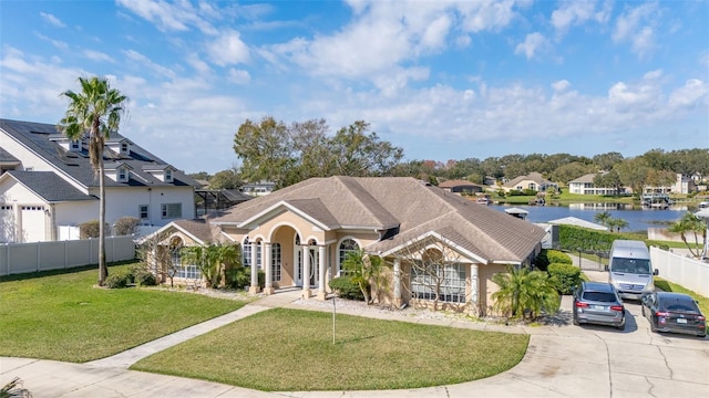 view of front of property with a front yard and a water view