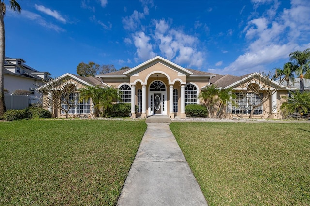 ranch-style home featuring a front lawn