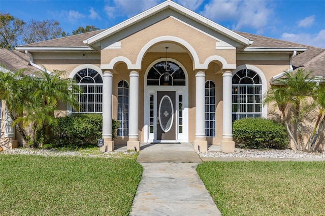 doorway to property featuring a lawn