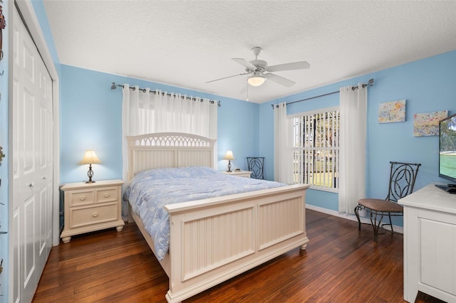 bedroom featuring a textured ceiling, a closet, ceiling fan, and dark hardwood / wood-style flooring