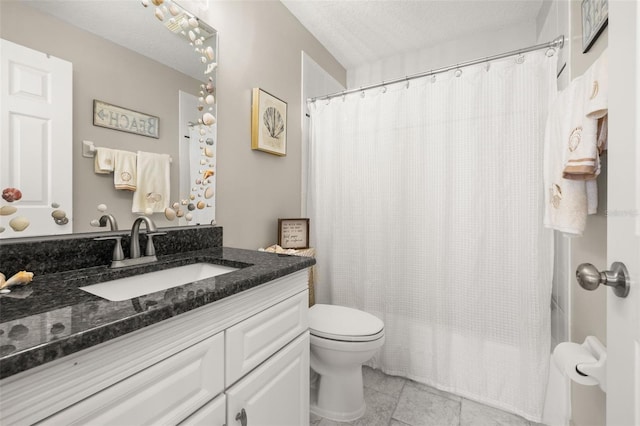 bathroom with toilet, tile patterned floors, vanity, and a textured ceiling