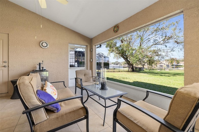 sunroom featuring vaulted ceiling and ceiling fan