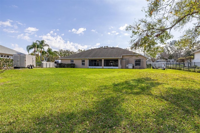 back of house featuring a lawn