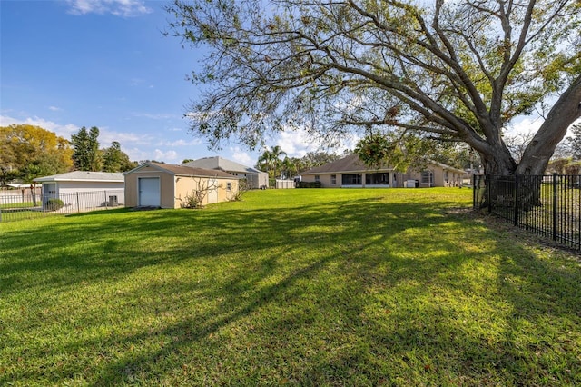 view of yard featuring an outbuilding and a garage