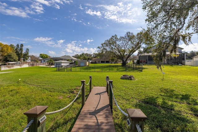 dock area with a yard and a water view