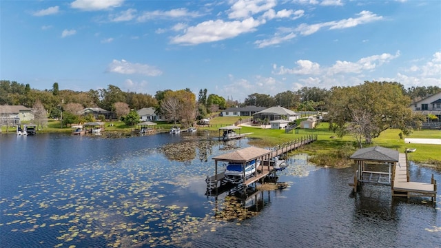 dock area featuring a water view and a lawn