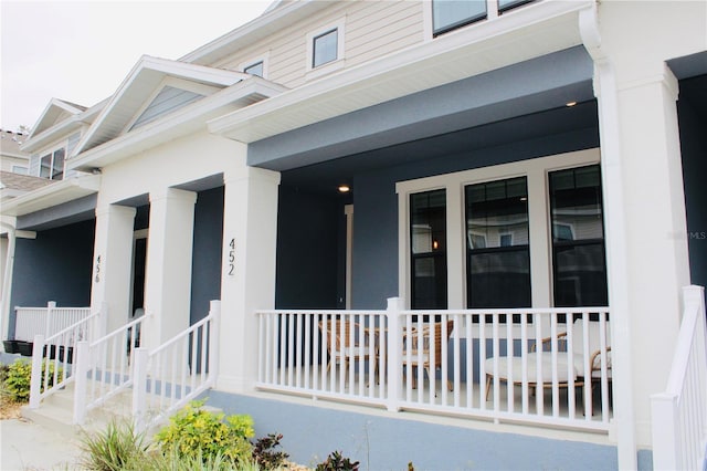 view of side of property featuring covered porch