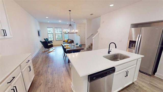452 Diamond Dove Cv, Winter Springs, FL 32708 - kitchen featuring an island with sink, white cabinetry, sink, stainless steel appliances, and light wood-type flooring