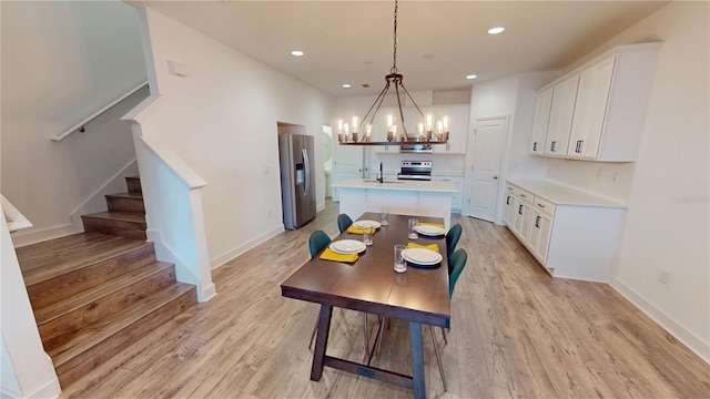 452 Diamond Dove Cv, Winter Springs, FL 32708 - dining room featuring light wood-type flooring, sink, and a notable chandelier