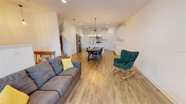 452 Diamond Dove Cv, Winter Springs, FL 32708 - living room featuring a notable chandelier and light hardwood / wood-style flooring