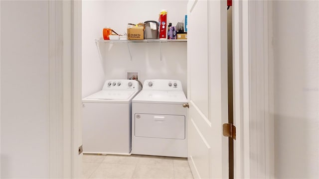 452 Diamond Dove Cv, Winter Springs, FL 32708 - clothes washing area with washer and clothes dryer and light tile patterned floors