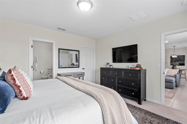 bedroom featuring visible vents, light colored carpet, a textured ceiling, and light tile patterned flooring