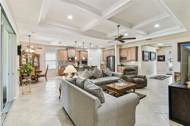 living room featuring crown molding, ceiling fan, coffered ceiling, and beamed ceiling