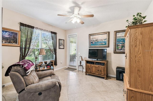 living room with ceiling fan and light tile patterned floors