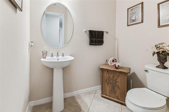 bathroom featuring sink, tile patterned flooring, and toilet