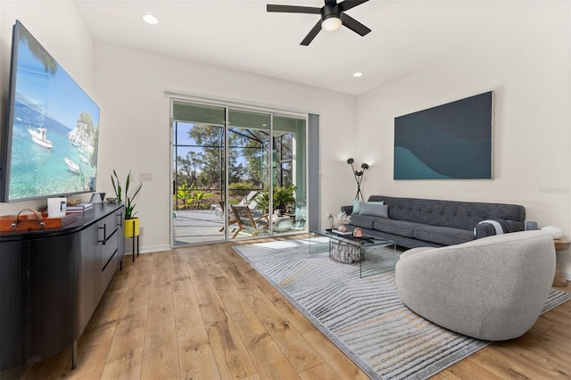 living area with light wood finished floors, a ceiling fan, and recessed lighting