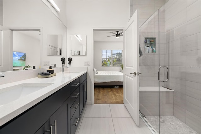 ensuite bathroom featuring a shower stall, a ceiling fan, a sink, and ensuite bathroom