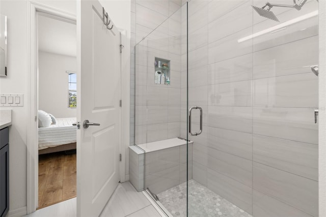 bathroom with ensuite bathroom, a shower stall, and vanity