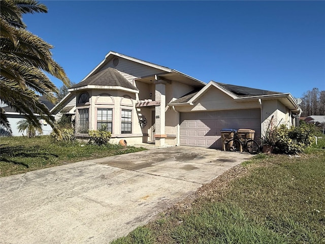 view of front of property with a garage and a front lawn