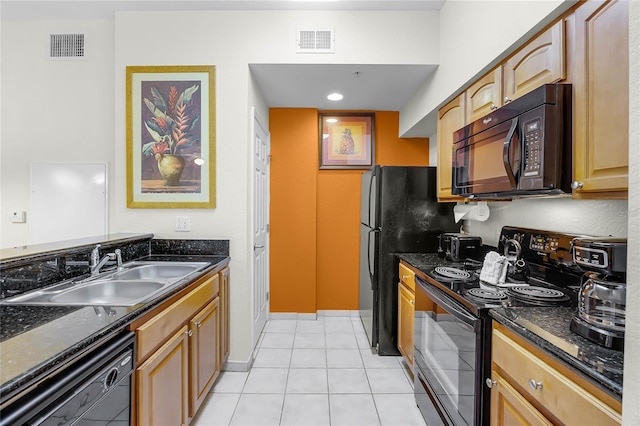 8100 Poinciana Blvd Unit 2501, Orlando, FL 32821 - kitchen featuring light tile patterned floors, a sink, visible vents, black appliances, and dark stone countertops