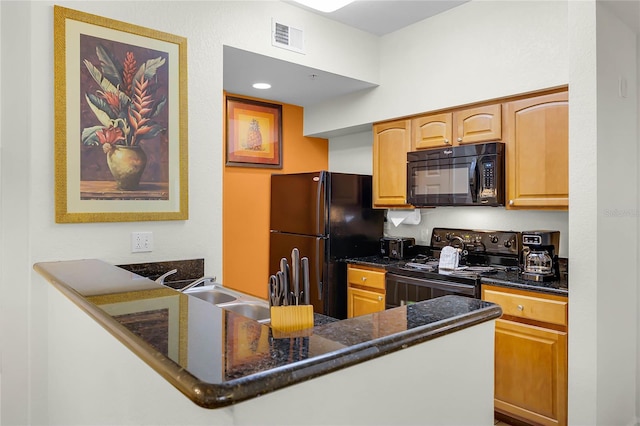 8100 Poinciana Blvd Unit 2501, Orlando, FL 32821 - kitchen featuring a peninsula, black appliances, visible vents, and dark stone counters
