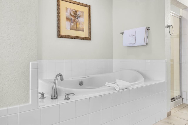 8100 Poinciana Blvd Unit 2501, Orlando, FL 32821 - bathroom featuring tile patterned flooring, a bath, and a shower stall
