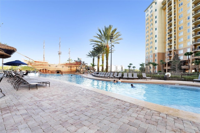 8100 Poinciana Blvd Unit 2501, Orlando, FL 32821 - community pool featuring a patio area and fence