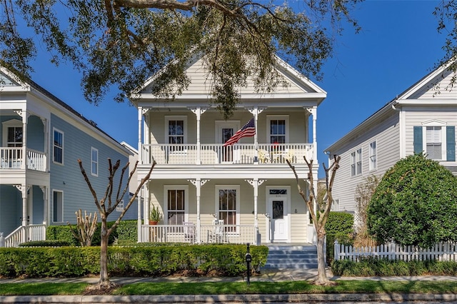 neoclassical / greek revival house featuring a balcony and covered porch