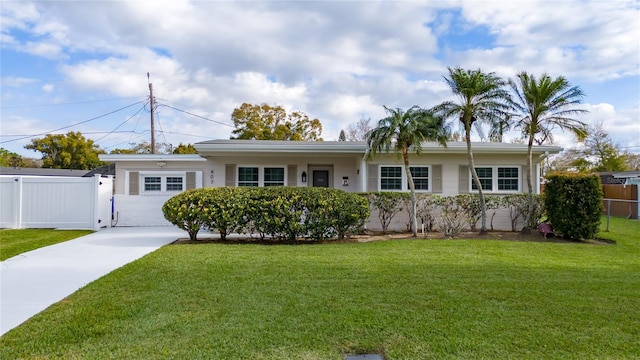 ranch-style home with a front yard and a garage