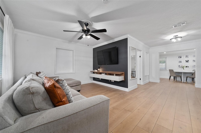 living room with a textured ceiling, crown molding, ceiling fan, and light hardwood / wood-style flooring