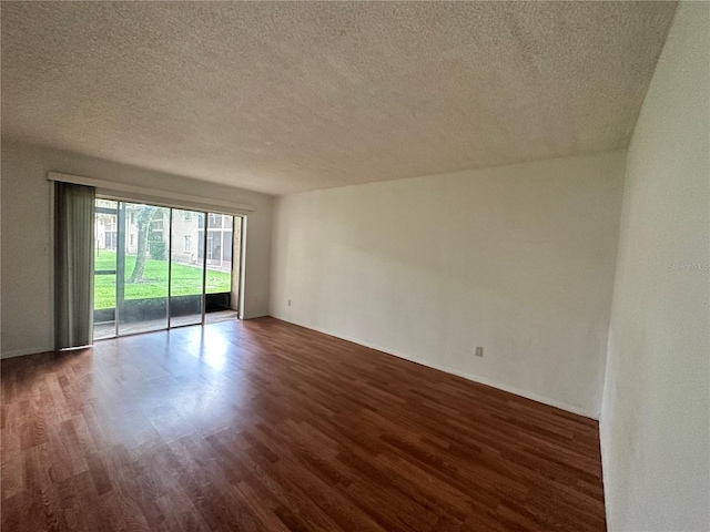 unfurnished room featuring dark wood-style floors and a textured ceiling