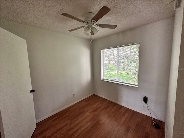 empty room with baseboards, a textured ceiling, a ceiling fan, and wood finished floors