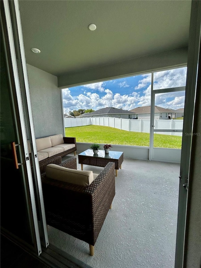 sunroom / solarium with plenty of natural light and a residential view