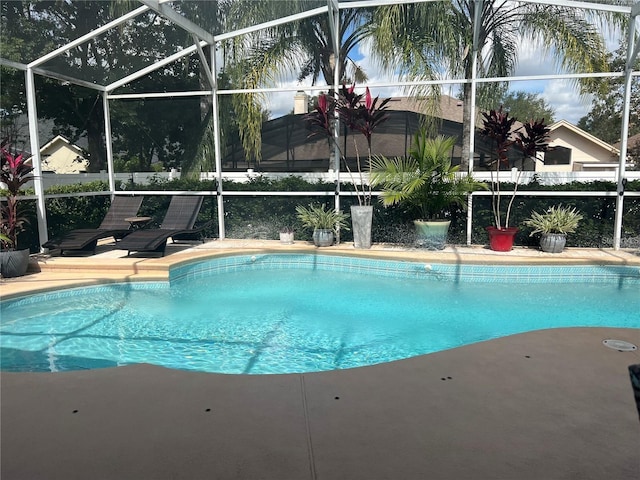 view of swimming pool featuring a lanai